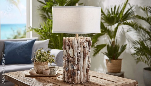 A stylish, coastal-inspired table lamp with a unique driftwood and seashell design sits on a rustic wooden coffee table, highlighting a tranquil, beachy living area.
