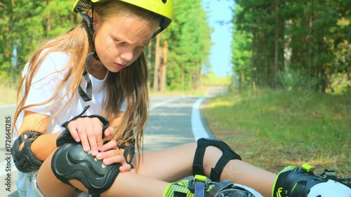 Knee injury and a girl on roller skates sitting on the floor outside. Sports, emergency medical care and a hurt leg after fall.