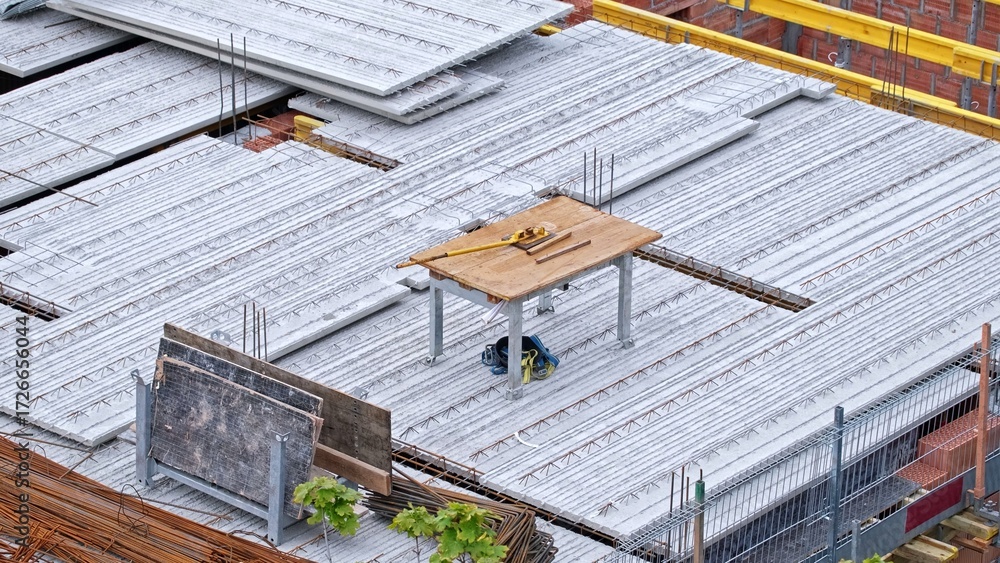 Naklejka premium Multistory Building Construction Site with Precast Reinforced Concrete Ceiling Slabs and Metal Rebar Rods