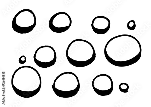 A collection of hand-drawn circles, varying in size and scattered across a white background, symbolizing abstract shapes and simple forms