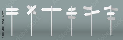 Arrow sign on pole set with white directional markers on posts for wayfinding and navigation systems. Crossroad signposts with multiple pointing boards for outdoor guidance. Street direction indicator