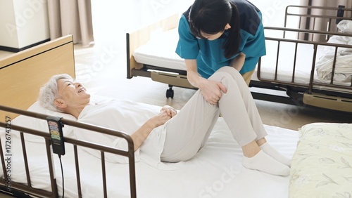 高齢者の体位変換を行うアジア人介護士
