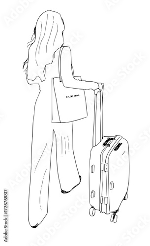 Elegant woman traveler with a luxury Balenciaga tote bag and rolling suitcase, capturing stylish modern travel and fashion.
