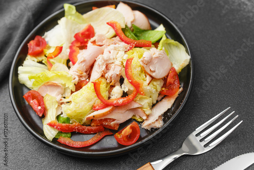 Quadro su tela Chicken salad with lettuce tomato and red pepper concept for homemade meal or bi