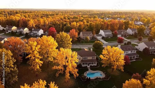 Golden autumn colors wash over suburban homes and lush forests in this dynamic aerial video, perfect for real estate promos and seasonal content