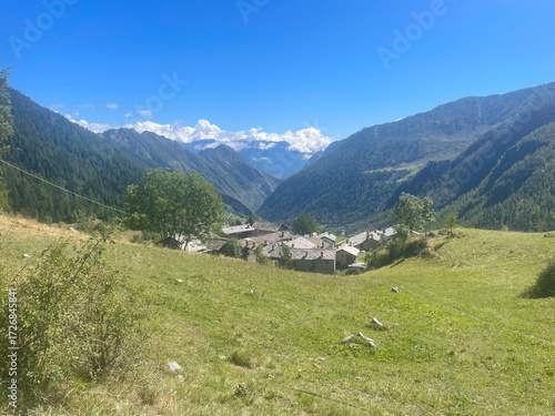 Scenic mountain landscape in the Champorcher Valley, located within the Mont Avic Natural Park in the Aosta Valley, Italy. A small alpine village