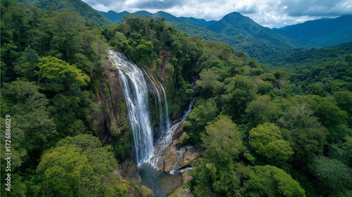 Majestic waterfall surrounded by lush tropical jungle, cinematic drone perspective, untouched natural wonder