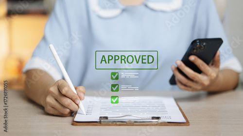 Fotografía Approved loan application with checklist, smartphone and stylus, digital lending
