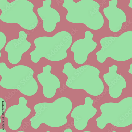 Abstract seamless cow print pattern featuring irregular amoeba spots in vibrant mint green on a bold pastel pink background for a modern Y2K aesthetic design.