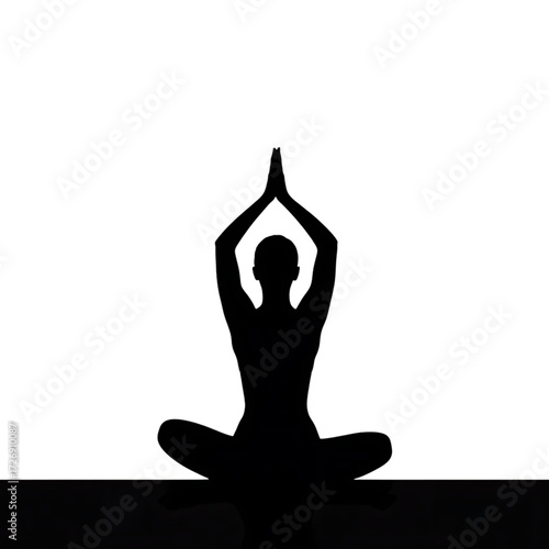 A person practicing yoga in a dimly lit room, focusing on their pose amidst the darkness.