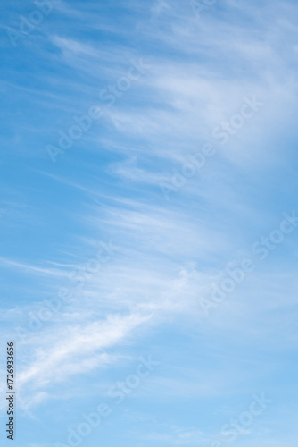 Fotografie Blue sky with graceful white clouds. Diagonal cloud background.