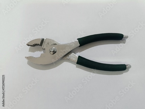 Close-up photo of a metal plier tool with rubber handles isolated on white background