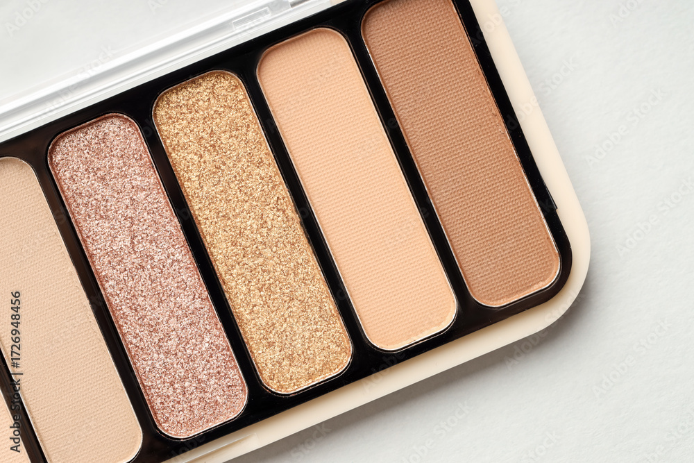 Fototapeta premium Beautiful eyeshadow palette on white table, top view