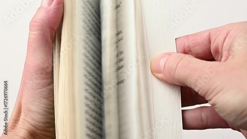 Close up hands quickly flicking through the pages book. Speed reading and studying, education