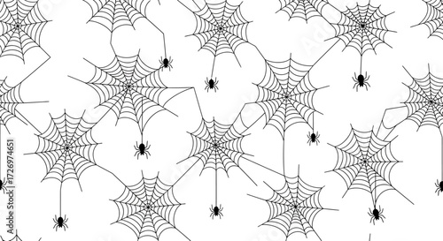 A seamless pattern of black and white spiderwebs with small spiders hanging from threads, perfect for Halloween decorations.
