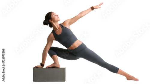 Woman practicing yoga pose with block, white isolated background