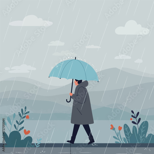 A person in a dark coat walks through the pouring rain holding a light blue umbrella.