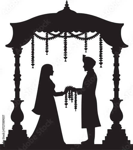 Indian wedding ceremony silhouette couple exchanging garlands under canopy