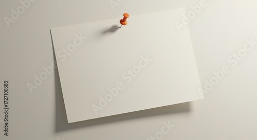A blank white rectangular note card held by a single red pushpin against a neutral wall, offering a clean placeholder for messages or announcements