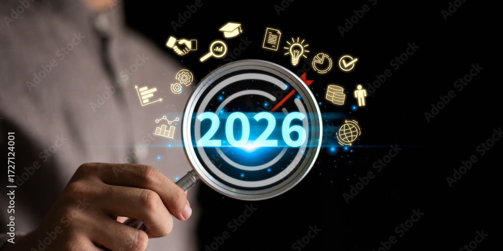 Fototapeta premium Concept of business goals and strategic planning 2026 with magnifying glass focusing on target, innovation, success, growth, and future achievement in finance, education, global business strategy.