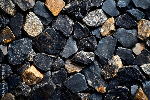 Close up shot of a pile of dark and light colored rocks filling the entire frame of the image space