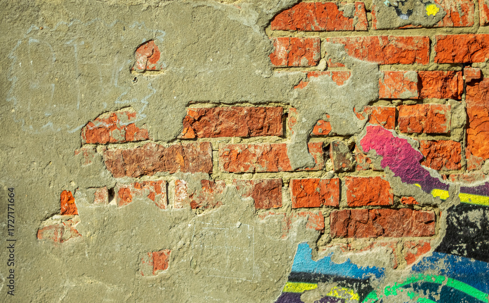 Naklejka premium Peeling plaster and paint from the base of the wall as an abstract background.