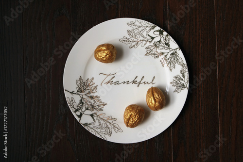 Thanksgiving plate overhead with walnuts and gold leaf details