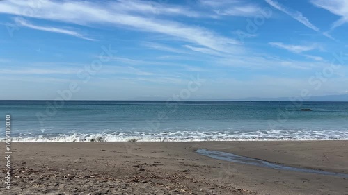 真夏の青い空と白い波がきれいに割れるビーチ