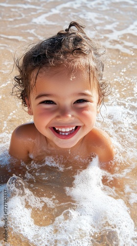 Joyful child portrait on sandy beach, sunlit waves glowing in background, natural beauty and sharp details highlight pure happiness.
