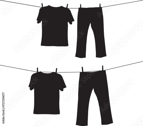 Black silhouette of t shirts and pants drying on a clothesline silhouette