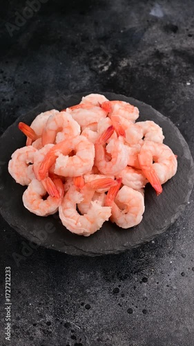 Freshly cooked shrimp piled high on a black stone plate ready for delicious seafood recipes and gatherings