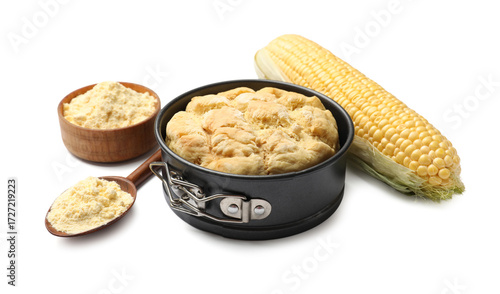 Freshly baked cornbread loaf, flour and cob isolated on white