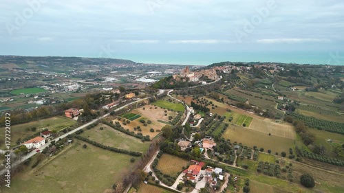 Aerial drone footage flying above the Italian countryside, showcasing traditional villages, rolling hills, and picturesque rural landscapes.