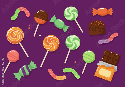 Assortment of colorful candies including lollipops gummy worms and chocolate on a purple background