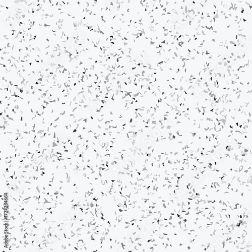 Abstract terrazzo seamless pattern with scattered stone chips in gray and black tones on white background texture.