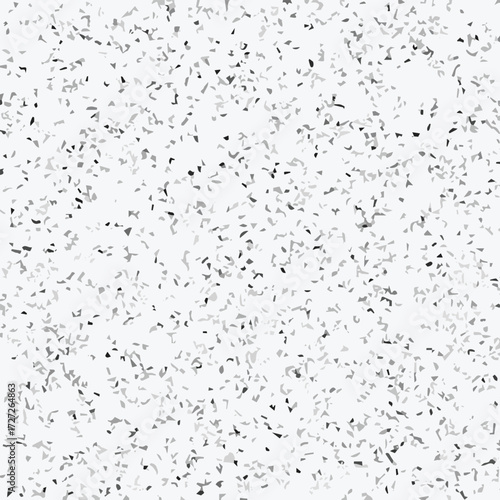 Abstract terrazzo seamless pattern with scattered stone chips in gray and black tones on white background texture.