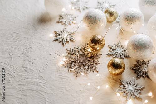 Golden christmas ornaments and bows on white background