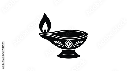 Traditional indian oil lamp with a flame and decorative floral pattern on a white background