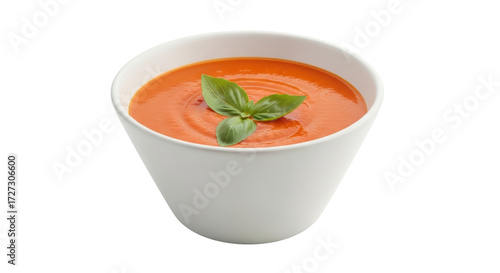 Isolated Tomato soup in white bowl topped with basil leaves, healthy gourmet meal
