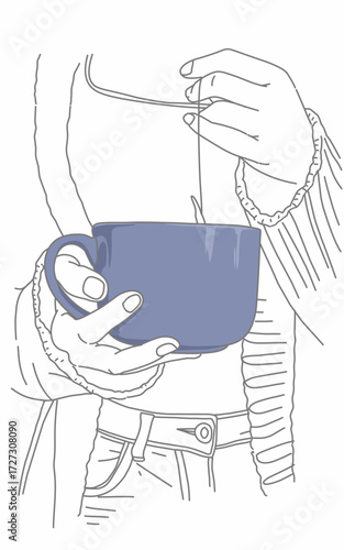 hand holding a cup of tea on blue mug