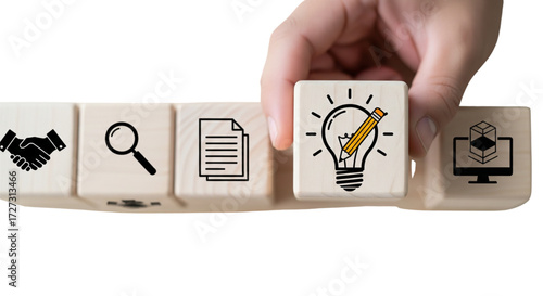 Hand placing lightbulb idea block into business strategy process. Wooden cubes for innovation, planning, development on white background.