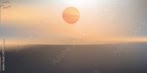 Out of focus sun setting over the ocean glowing orange with dark blue background