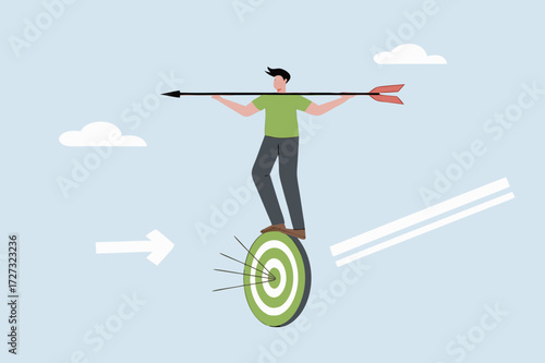 businessman balances and directs rotating archery target with arrow hit bullseye