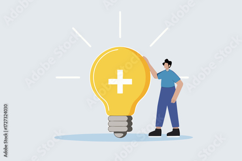Positive thinking, businesswoman positioned with glowing light bulb concept featuring optimistic symbol.