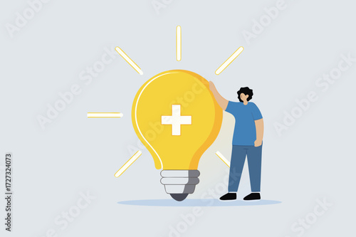 Positive thinking, businesswoman positioned with glowing light bulb concept featuring optimistic symbol.