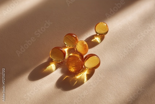 Wallpaper Mural Golden softgels on a beige surface Torontodigital.ca