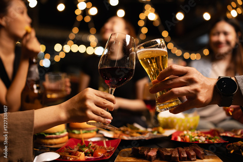 Happy Friends Celebrating Together at Night, Young Asian Group of Friends Having Fun and Toasting Drinks Outdoors At Night, Enjoying a Celebration Concept.