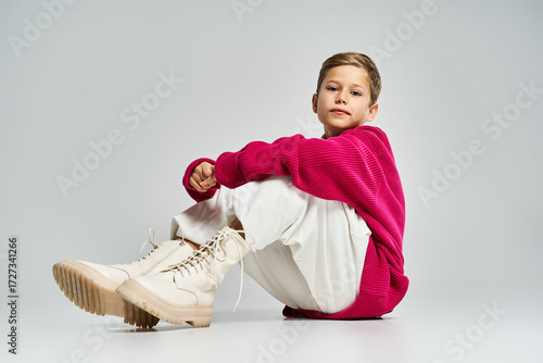 Wallpaper Mural Stylish preteen boy showcases trendy winter fashion in a modern studio setting Torontodigital.ca