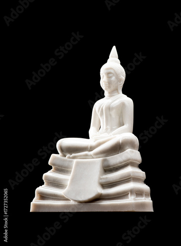 White Buddha statue for worship on the set of altar table, isolated on black background