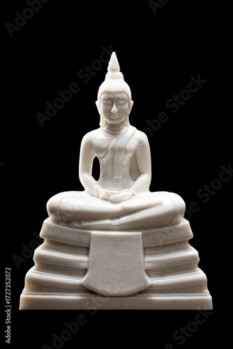 White Buddha statue for worship on the set of altar table, isolated on black background